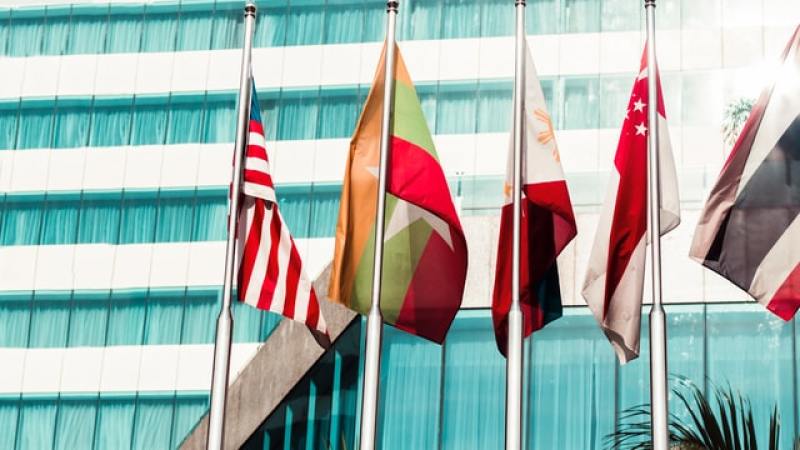 Myanmar's flag along with others outside a building in the country