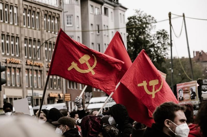 People waving communist flags on the streets