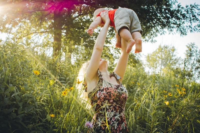 mom rejoicing lifting her baby up