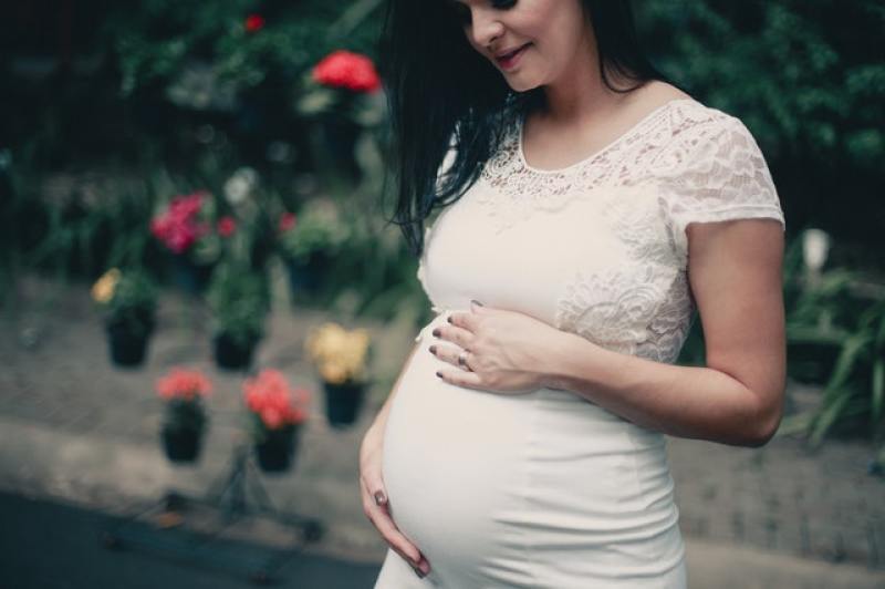 pregnant mom holding her baby inside her womb