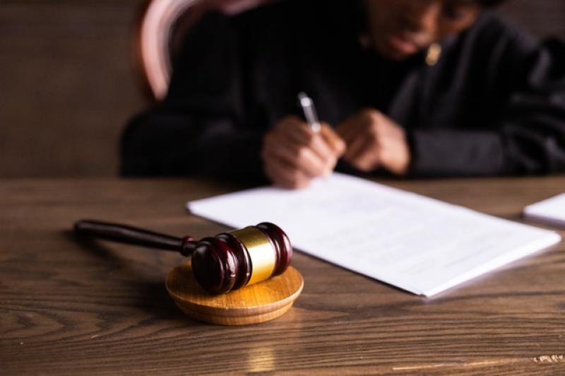 judge reviewing a lawsuit in front of a gavel