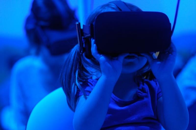 little girl using VR goggles