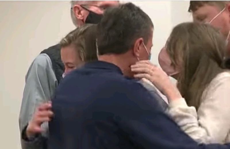 David Nelson being comforted by the family of Pastor Verlyn Strenge