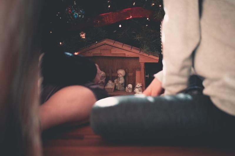 family setting up a Christmas nativity scene