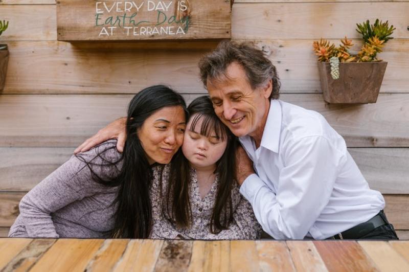 Parents hugging beloved child