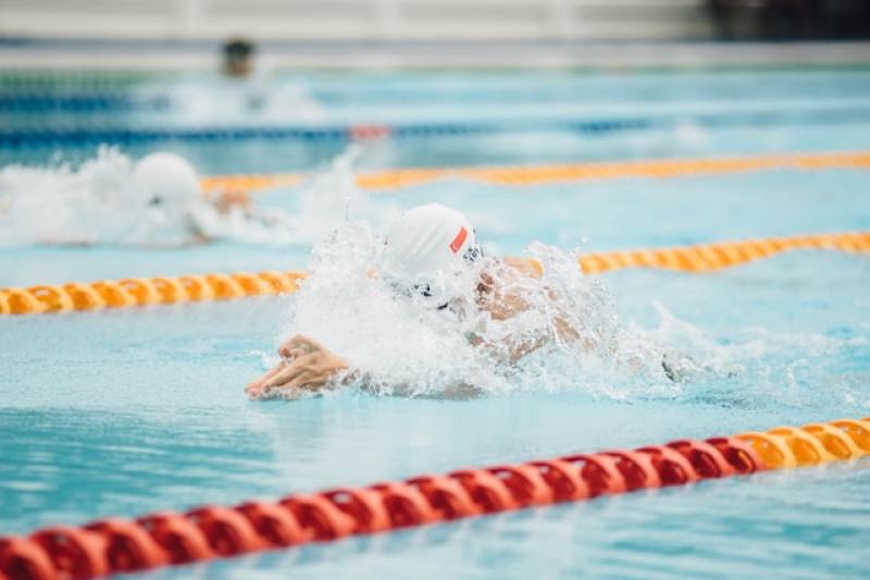 swimmer swimming in swimming pool
