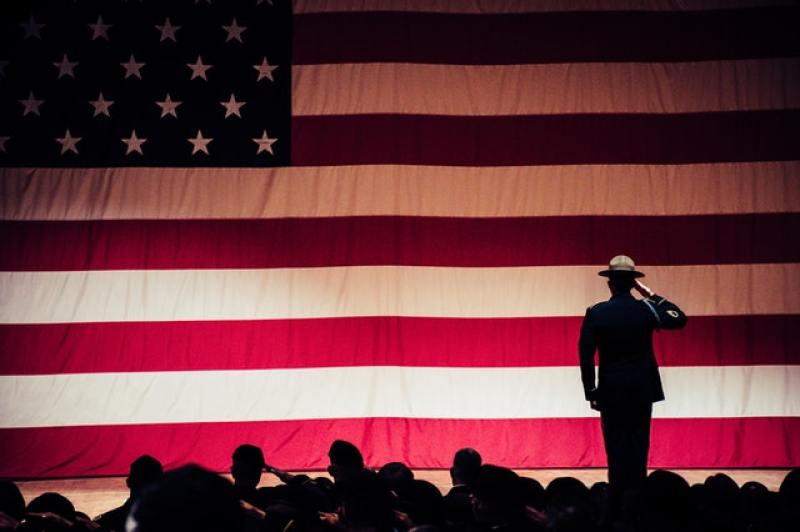 Soldier giving a salute to the American flag