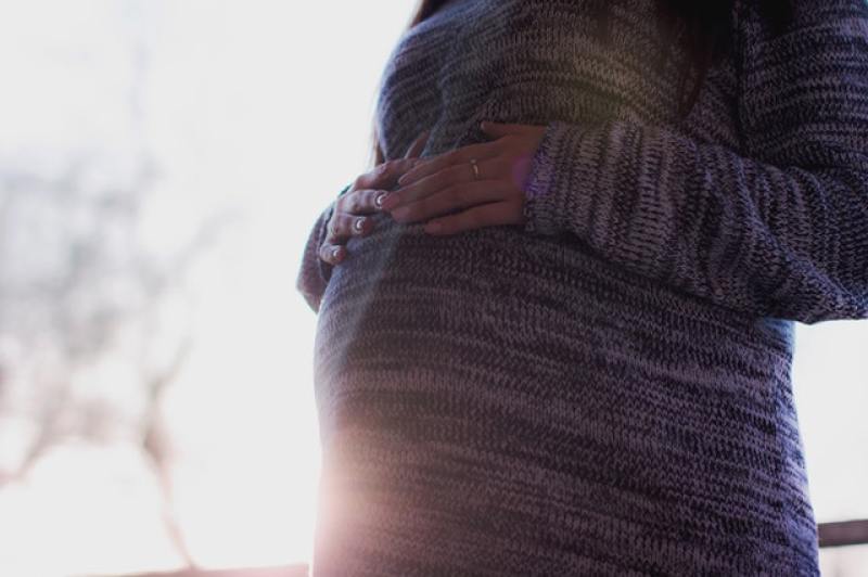 pregnant mother holding her tummy
